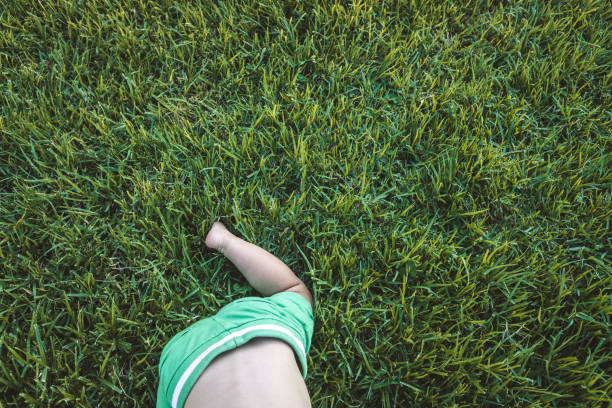istock Baby crawling on the grass, with a green background with copy space. 1709581989
