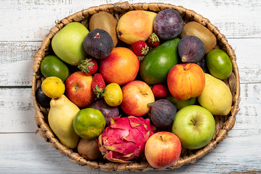 Fresh fruits in a wicker basket. Various colorful fruits. top view
