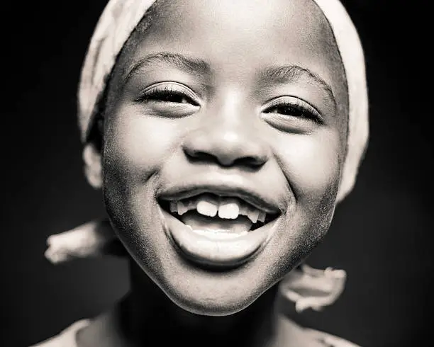 Photo of Young African Girl Laughing (Isolated on Black)