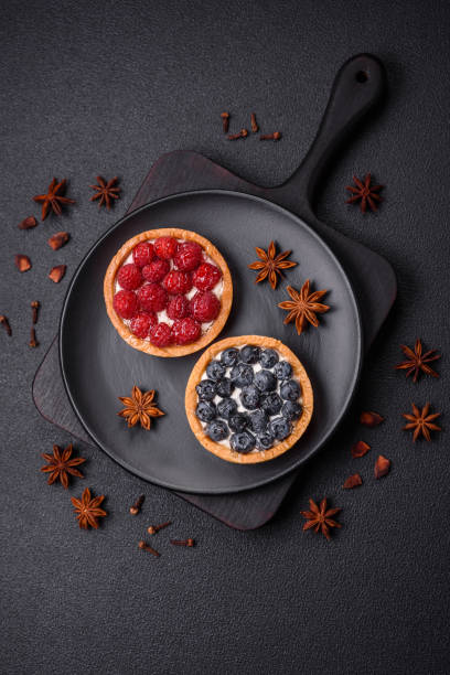 Delicious fresh sweet round tart with ripe blueberries and cream