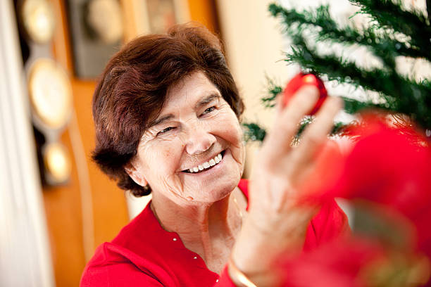 istock Senior woman decorating a christmas tree 170959596