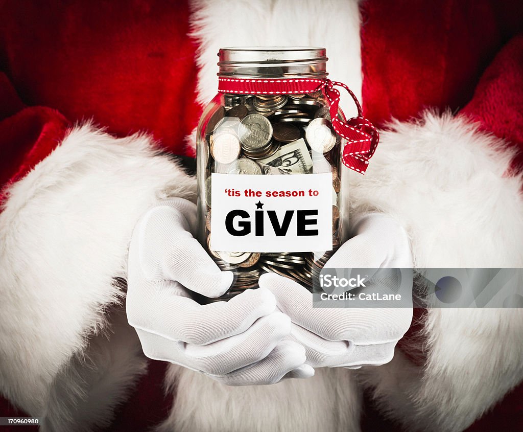 'Tis the Season to Give Santa with donation jar. Christmas Stock Photo
