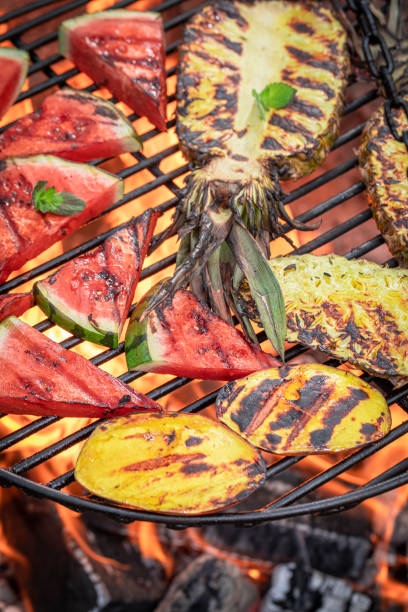 istock Roasted watermelon and pineapple with fire on grill grate. 1709619195