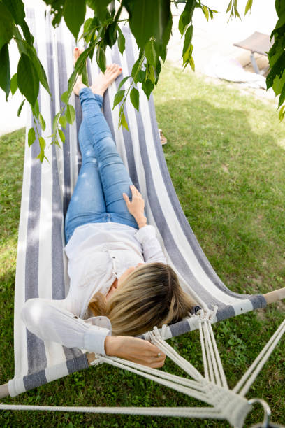 istock young woman is relaxing in hammock in garden 1709621981