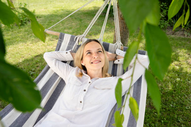 istock young woman is relaxing in hammock in garden 1709623644
