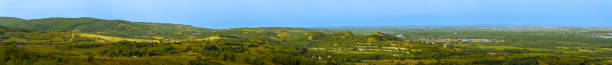 Panorama from one of the peaks of Fruszka Gora to the slopes, fields and the Danube River in the distance