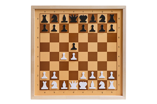 Queen's gambit in the form of chess pieces on a demonstration chessboard. Chess position, isolated on a white background