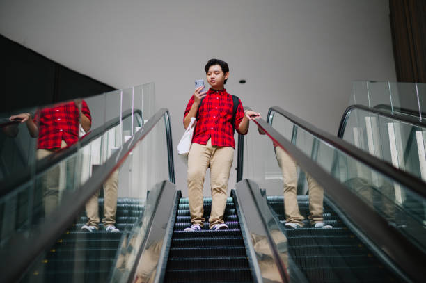 istock Asian Chinese using device in city. 1709639631