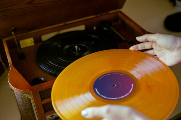 istock Woman putting vinyl on turntable 1709669859