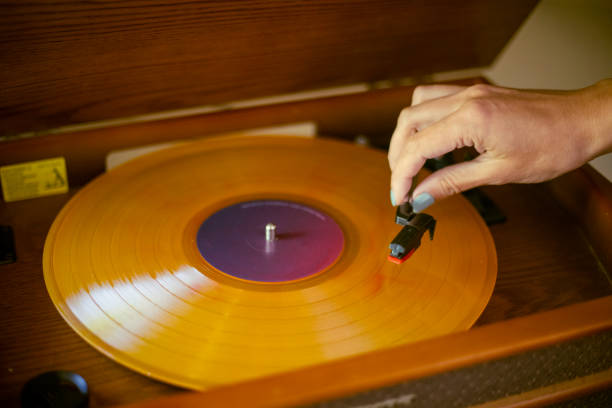 istock Woman putting vinyl on turntable 1709670456