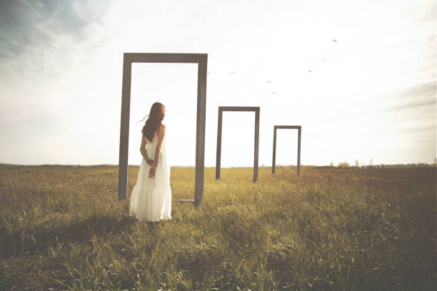 istock surreal moment of a woman pausing to decide whether she should take the path into the unknown through doors in nature, abstract concept 1709680327