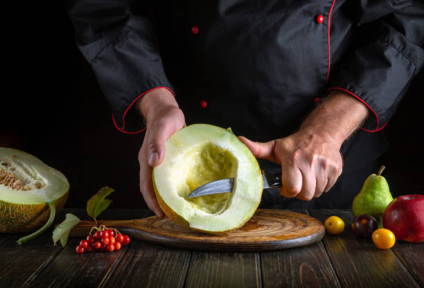 istock The chef cuts a ripe melon on a cutting board with a knife. Working environment with fruits on the restaurant kitchen table 1709700125