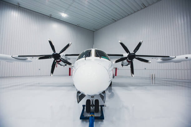 istock Twin engine turboprop aircraft parked in a white hangar 1709711740