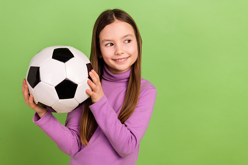 Photo of daughter young girl wear pink stylish turtleneck hold ball playing soccer game look mockup isolated on green color background.