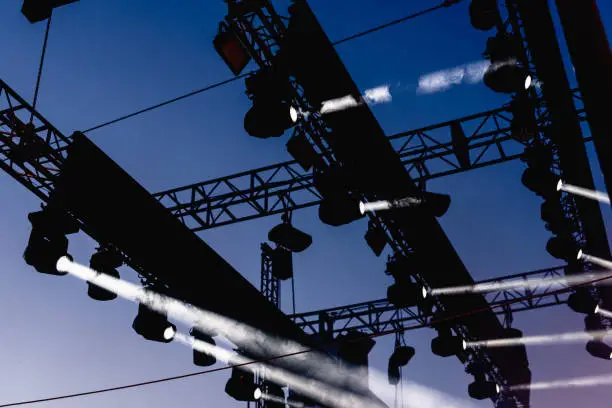 Installation of spotlights to illuminate a musical concert during rehearsals.