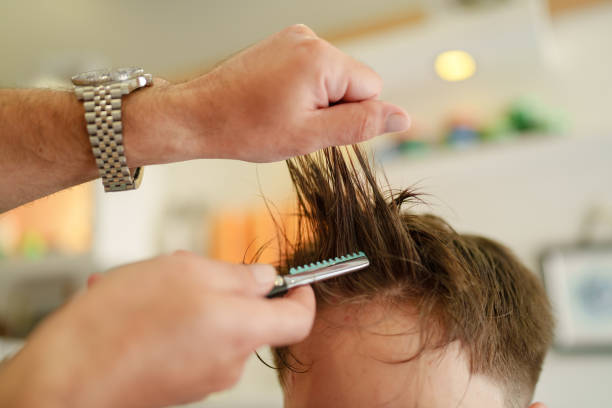 istock Barber is cutting hair with razor 1709762880