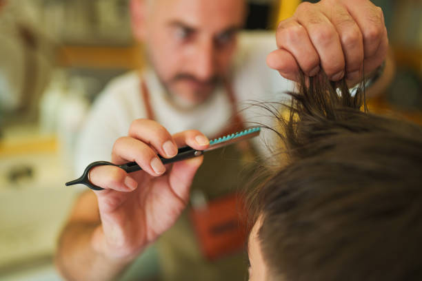 Part of a series of a boy having hair cut at the barber shop.