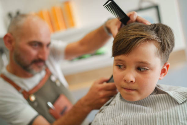 istock Kid is nervously looking to hair clipper 1709771170