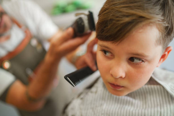 istock Kid is nervously looking to hair clipper 1709771703