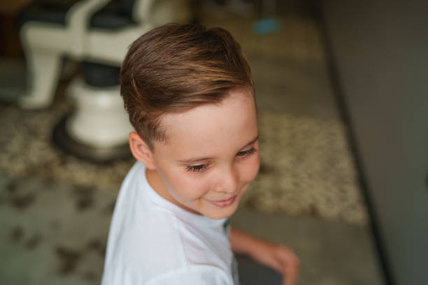 Part of a series of a boy having hair cut at the barber shop.