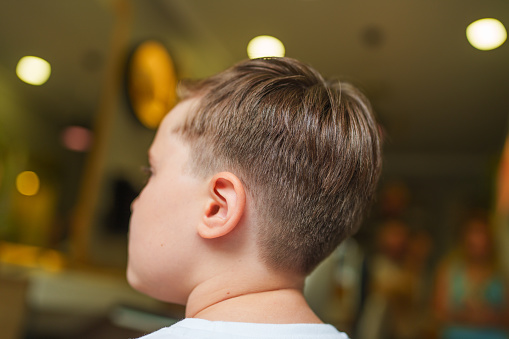 Part of a series of a boy having hair cut at the barber shop.