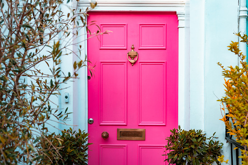 Vibrant pink front door of a residential house in the city of London.