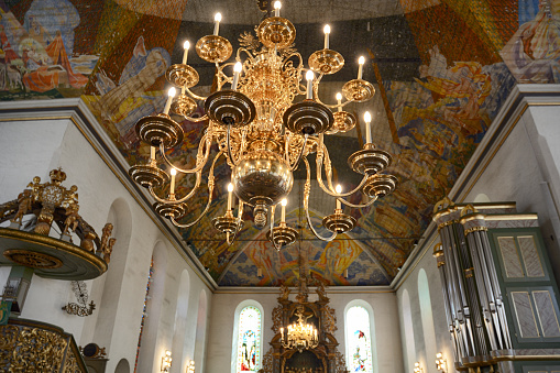 Interior of Oslo Cathedral (Oslo domkirke) with chandelier in foreground, Norway