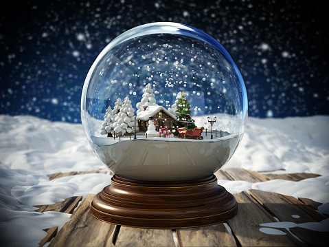 Christmas snowglobe and Merry Christmas text on snow covered old planks on a snowy night background. Christmas and new year concept