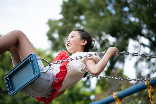 girl playing on a swing