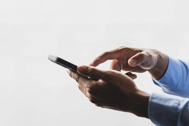 istock Male hand typing and searching on smartphone. 1709869648