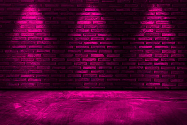 istock Dark pink red neon light on brick walls that are not plastered background and texture. Lighting effect dark pink red neon background. 1709872040