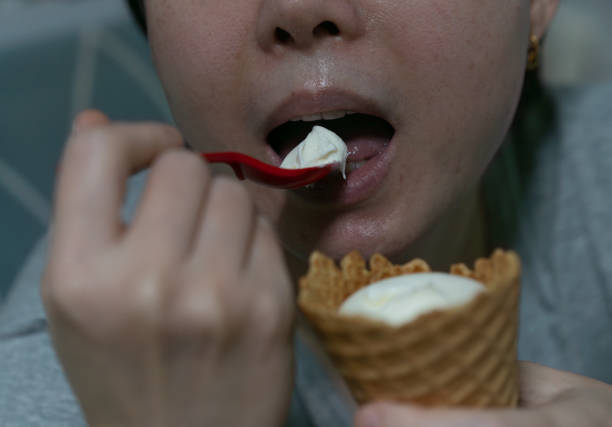 Mouth eat and hold icream ,close up