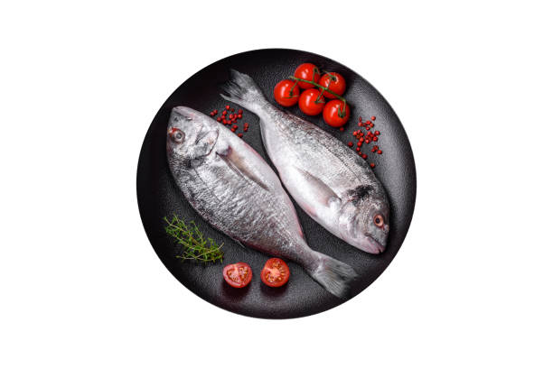 istock Fresh raw dorada fish with salt, spices and herbs 1709876390