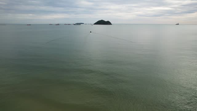 Long tail boat sailing over sea to island view from aerial