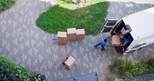 istock High Angle View Of Delivery Men Unloading The Cardboard Boxes 1709876550