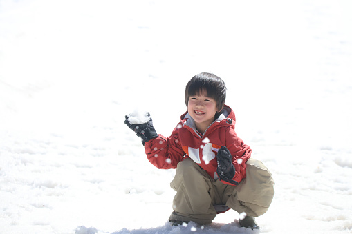 boy playing in the snow