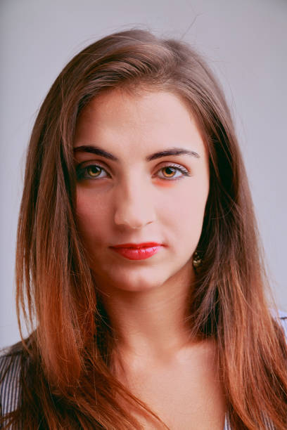 Frontal young woman portrait, serious, defiant expression
