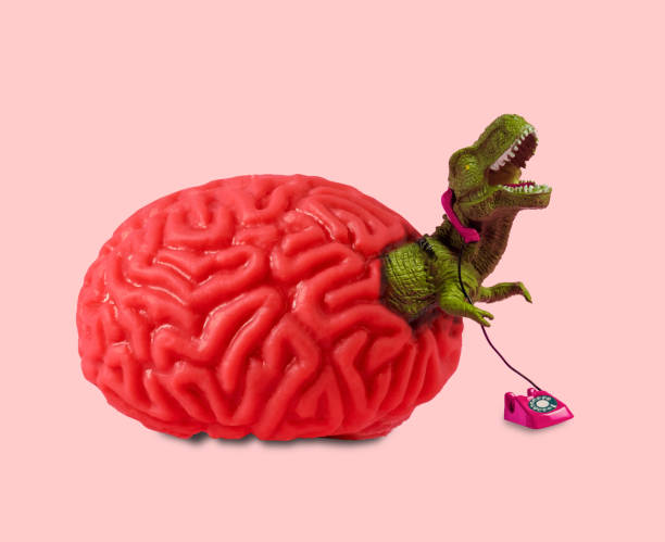 istock Human brain from which dinosaur climbs out talking on retro phone. Mental health problems concept collage. 1709918170