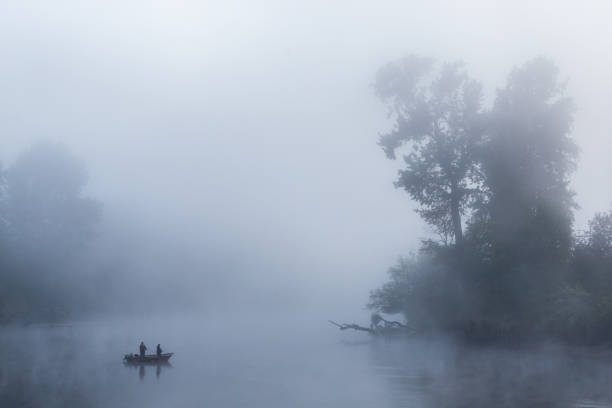 Fishermen wait for a fish on a beautiful misty morning