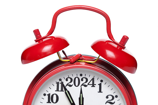 Red alarm clock set at ten isolated over white background close-up with clipping path