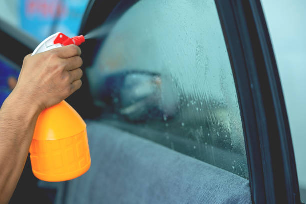 istock Technician uses equipment to install car window film. 1709932846