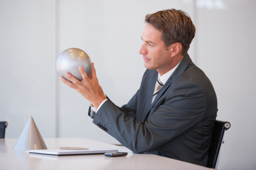 portrait of man holding a crystal ball with its reflection upside down