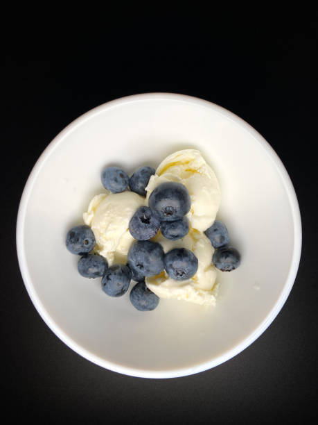 istock Blueberries and ice cream in a bowl 1709950617