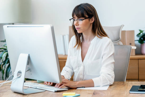 istock Concentrated young woman working with computer in a modern startup 1709961468