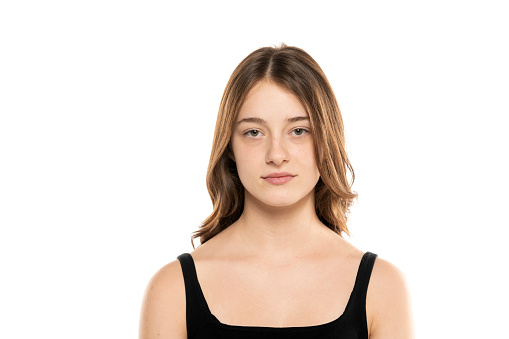 beautiful young women with long hair and no makeup on a white studio background.