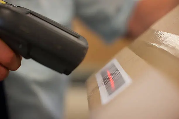 Photo of Close up of worker scanning box