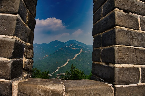 An aerial view of the Great Wall of China, winding its way through the mountains