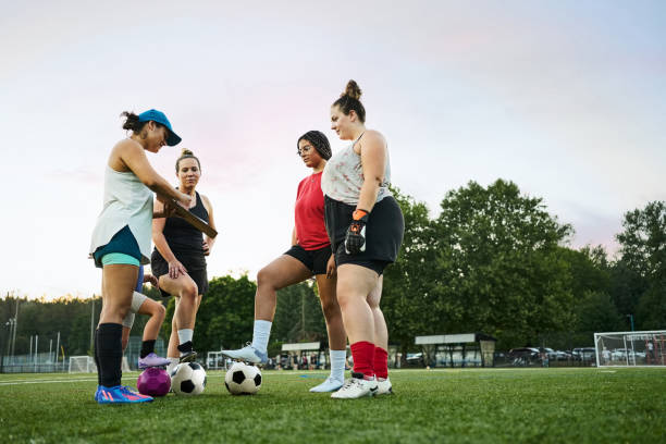 istock Young female soccer coach explaining game plan to her team during a practice 1710051291