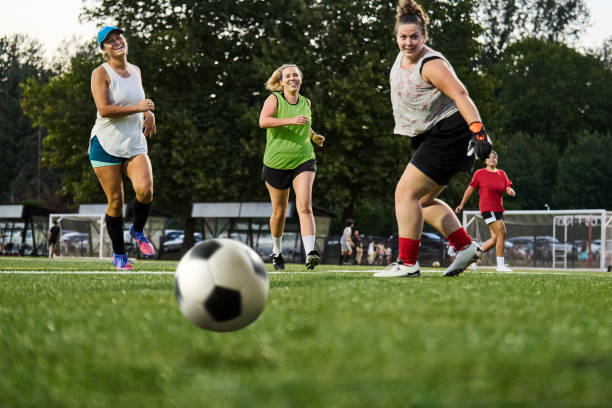 Female soccer team players stretching pre game