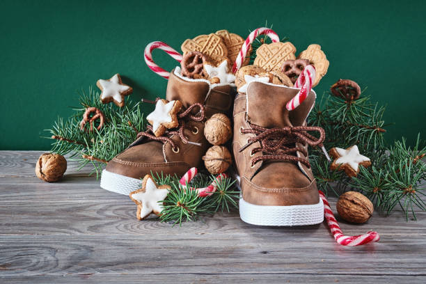 Saint Nicholas Day or Nikolaus. Children shoes filled with traditional sweets stock photo